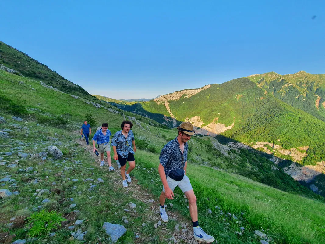 Hikers in single file on the open mountain trail between Umoljani and Lukomir